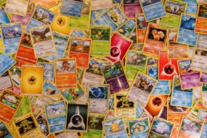 A vibrant banner displaying a variety of Pokémon cards, including booster packs, chase cards like Charizard and Umbreon VMAX, and Elite Trainer Boxes, showcasing the excitement of Pokémon TCG collecting.