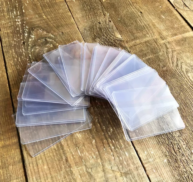 Stack of transparent top loaders for Pokémon cards, perfect for protecting valuable chase cards like Charizard VMAX and Umbreon VMAX from damage and wear.